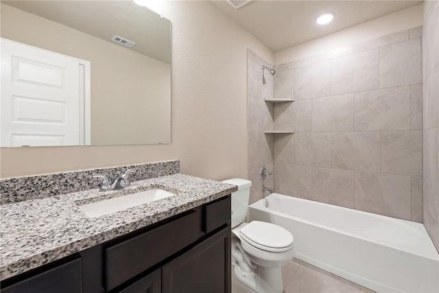 full bathroom with tiled shower / bath combo, toilet, and vanity