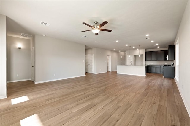 unfurnished living room with ceiling fan and hardwood / wood-style flooring