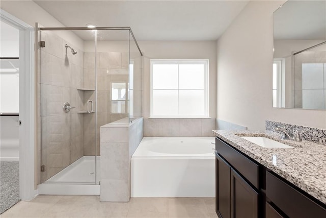 bathroom with tile patterned flooring, shower with separate bathtub, and vanity