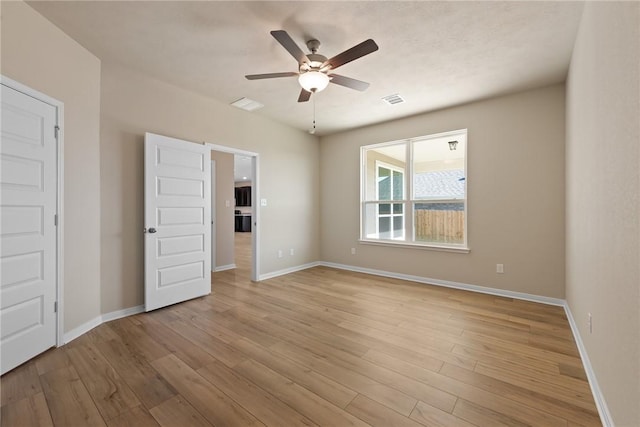 spare room featuring ceiling fan and light hardwood / wood-style floors