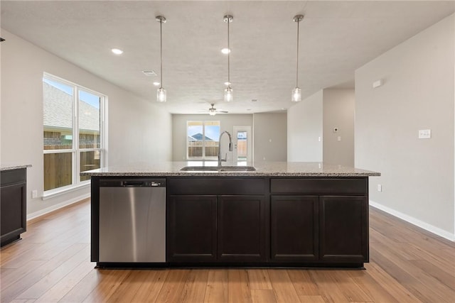 kitchen featuring sink, stainless steel dishwasher, plenty of natural light, and light hardwood / wood-style floors