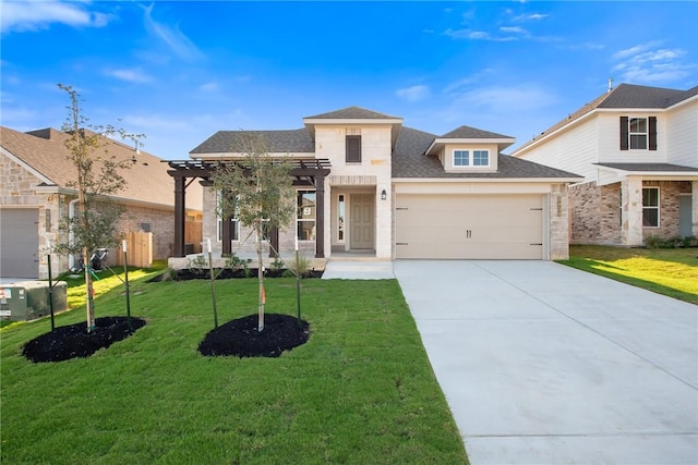 view of front of property featuring a front yard and a garage