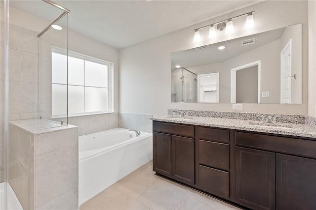 bathroom featuring tile patterned floors, vanity, and separate shower and tub