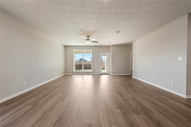 unfurnished room featuring hardwood / wood-style floors, a textured ceiling, and ceiling fan