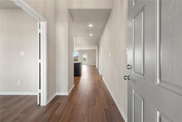 hallway with dark hardwood / wood-style floors