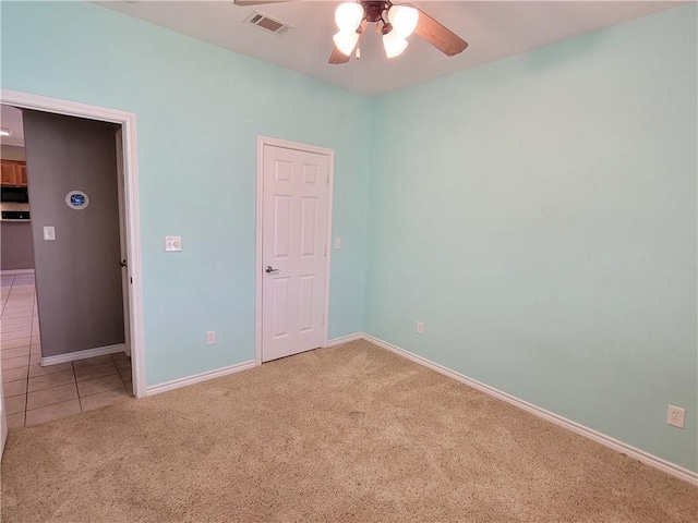 unfurnished room with ceiling fan and carpet floors