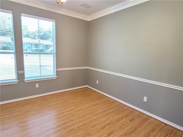 empty room featuring light hardwood / wood-style floors and ornamental molding