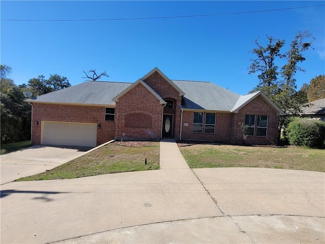 ranch-style house featuring a front yard and a garage