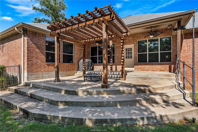 back of property with ceiling fan, a pergola, and a patio