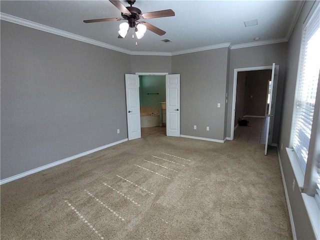 unfurnished bedroom featuring carpet flooring, ensuite bathroom, crown molding, and ceiling fan