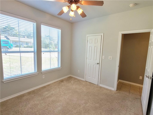 carpeted empty room featuring ceiling fan