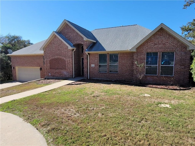 view of front of house featuring a garage and a front lawn