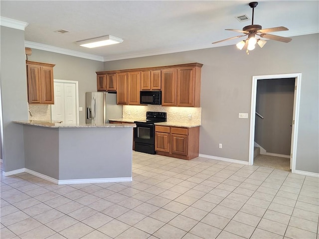 kitchen featuring decorative backsplash, light stone countertops, crown molding, and black appliances