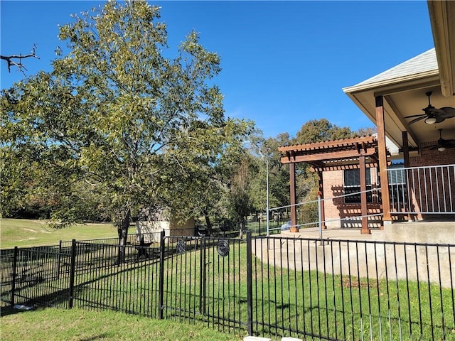 view of yard with ceiling fan and a pergola