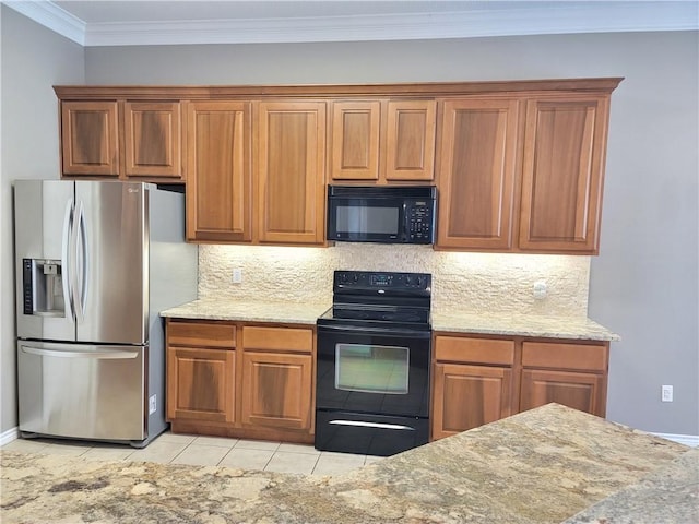 kitchen featuring black appliances, crown molding, decorative backsplash, light tile patterned flooring, and light stone counters