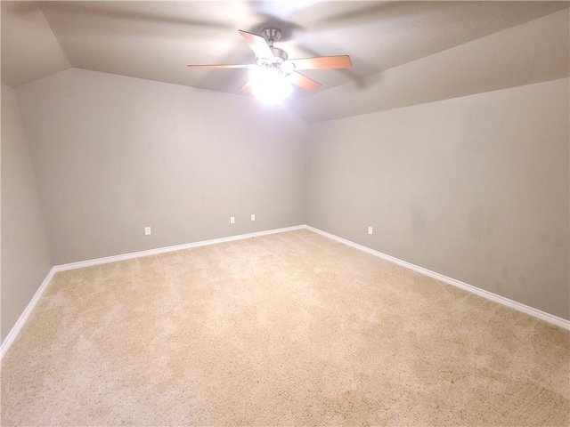 unfurnished room with carpet, ceiling fan, and vaulted ceiling