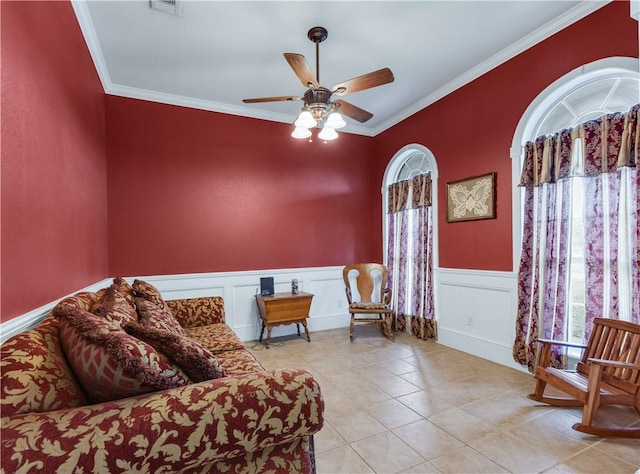 sitting room featuring light tile patterned floors, ceiling fan, and ornamental molding