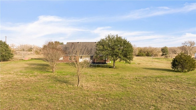 view of yard with a rural view and a trampoline