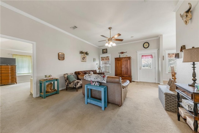 carpeted living room featuring ceiling fan and ornamental molding