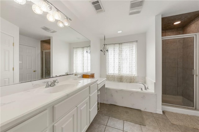 bathroom featuring tile patterned flooring, vanity, a chandelier, and plus walk in shower