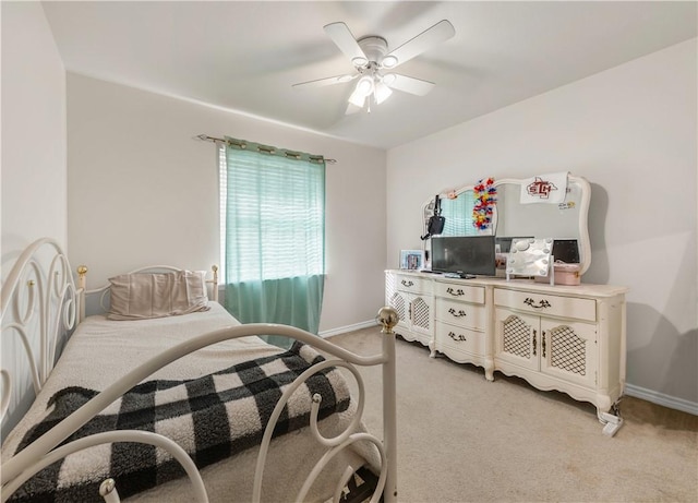 bedroom with ceiling fan and light carpet