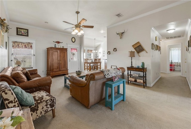 carpeted living room with ceiling fan, ornamental molding, and a wealth of natural light