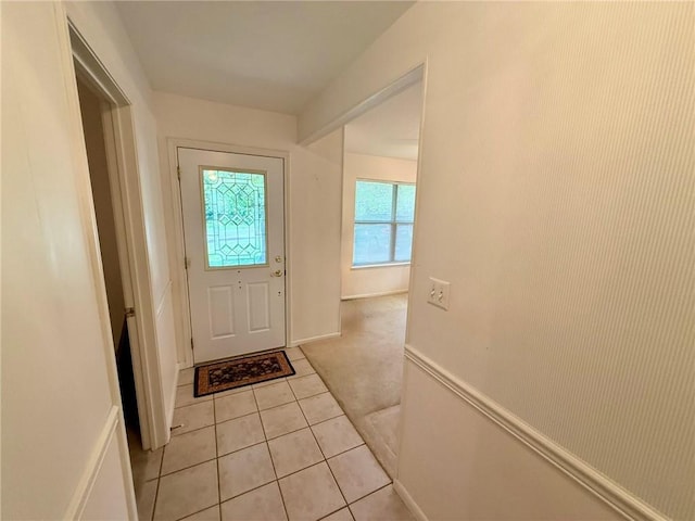 28 Sammy Snead Dr, Hilltop Lakes, TX 77871 - doorway to outside with light tile patterned floors, light colored carpet, and baseboards