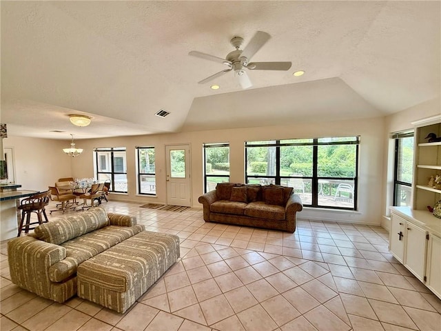 28 Sammy Snead Dr, Hilltop Lakes, TX 77871 - living room featuring light tile patterned floors, vaulted ceiling, a textured ceiling, a chandelier, and a ceiling fan