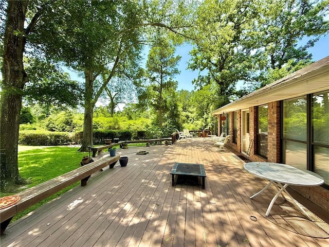 28 Sammy Snead Dr, Hilltop Lakes, TX 77871 - wooden terrace with a lawn and view of wooded area