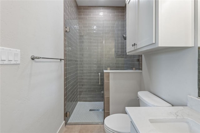 10732 Harvey Ranch Rd, College Station, TX 77845 - full bath featuring vanity, toilet, a stall shower, and tile patterned floors