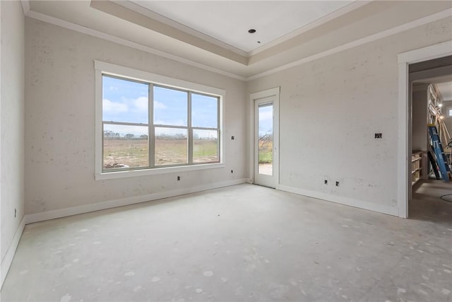 unfurnished room featuring crown molding, concrete flooring, and a raised ceiling