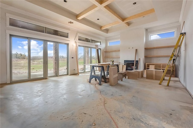 interior space featuring a fireplace, coffered ceiling, and beam ceiling