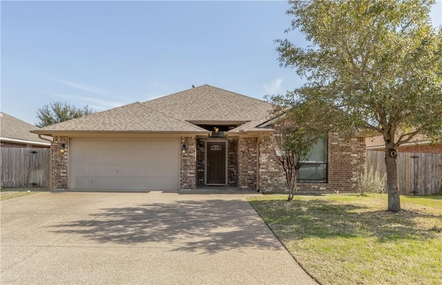 ranch-style house featuring brick siding, roof with shingles, an attached garage, and fence