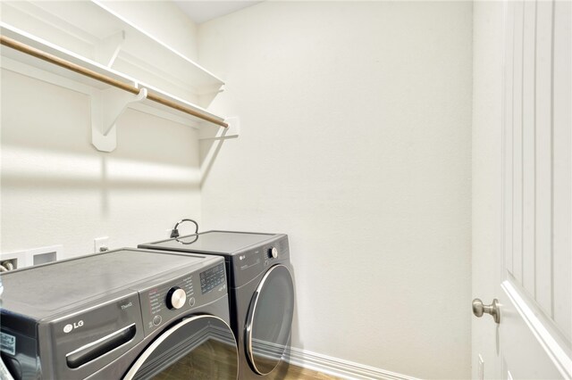 2124 Mountain Wind Loop, Bryan, TX 77807 - washroom with washer and clothes dryer and wood finished floors
