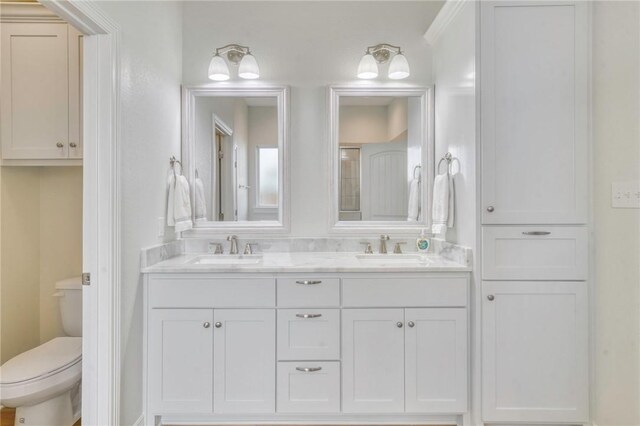 2124 Mountain Wind Loop, Bryan, TX 77807 - bathroom featuring double vanity and toilet