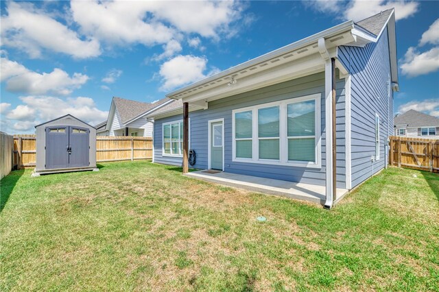 2124 Mountain Wind Loop, Bryan, TX 77807 - rear view of house featuring a fenced backyard, a storage unit, and a patio area