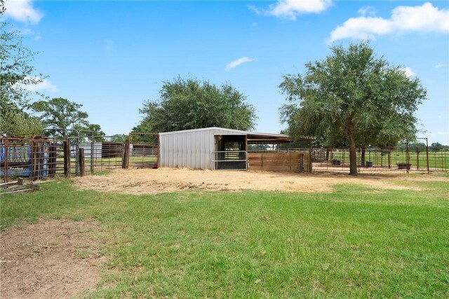 view of yard featuring a rural view and an outdoor structure