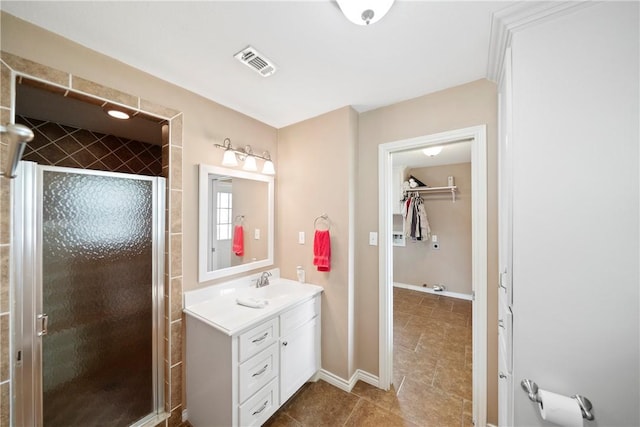 bathroom with tile patterned flooring, vanity, and an enclosed shower