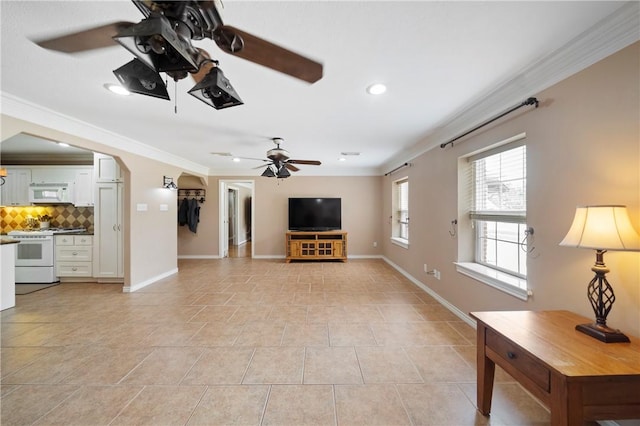 unfurnished living room featuring light tile patterned floors, ceiling fan, and ornamental molding