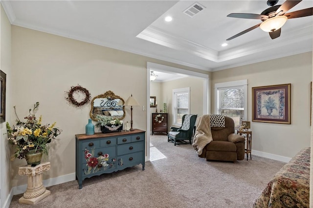 living area with crown molding, carpet flooring, and visible vents