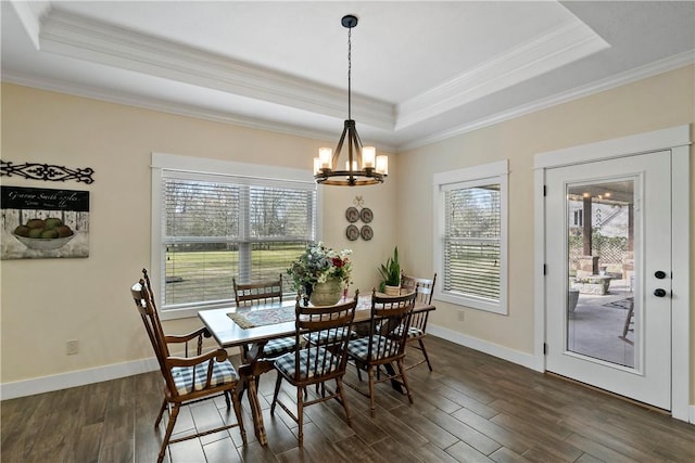 dining room with ornamental molding, a tray ceiling, and a wealth of natural light