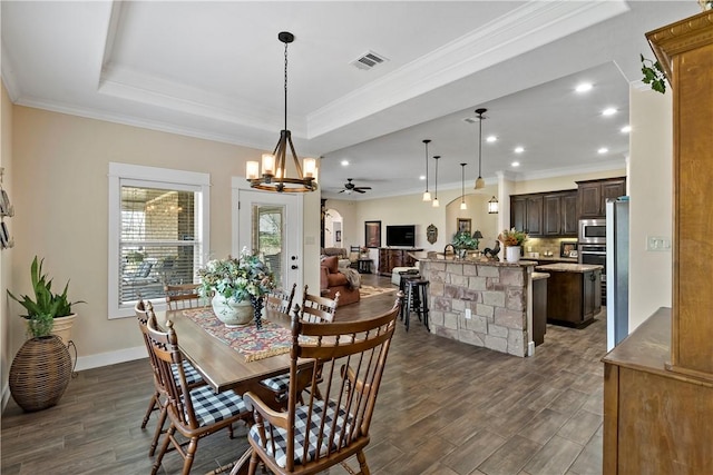 dining room with visible vents, crown molding, ceiling fan with notable chandelier, recessed lighting, and dark wood-type flooring