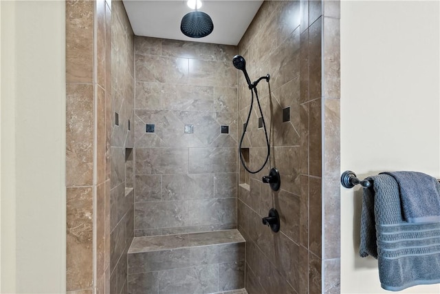 bathroom with tiled shower