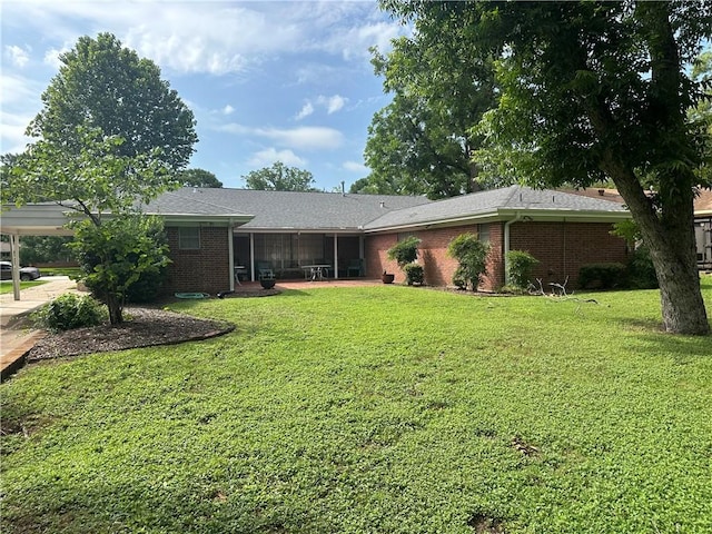 604 W Buck St, Caldwell, TX 77836 - view of front of home with brick siding, a front lawn, and a sunroom