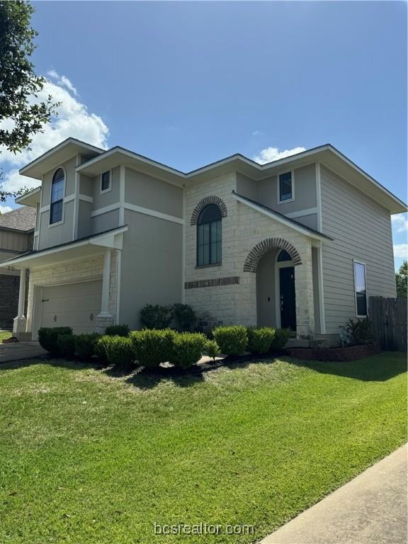 view of front of property with a front lawn and a garage