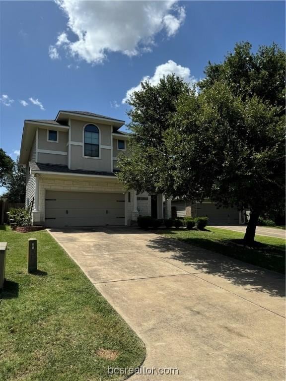 view of front of property featuring a front yard and a garage