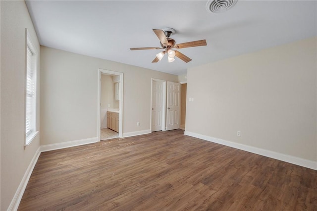 unfurnished bedroom with ceiling fan, connected bathroom, and hardwood / wood-style flooring