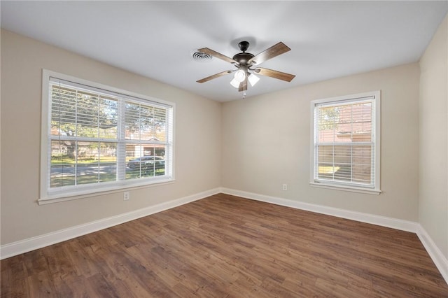 spare room featuring ceiling fan and dark wood-type flooring