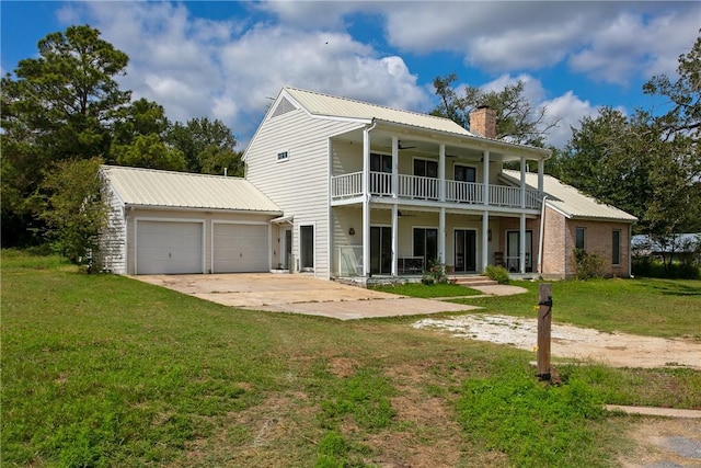 view of front facade with a porch, a balcony, and a front lawn