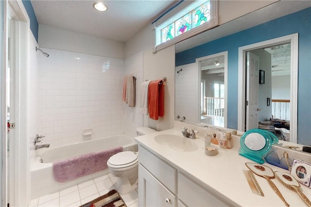 full bathroom with tiled shower / bath combo, tile patterned flooring, toilet, a textured ceiling, and vanity